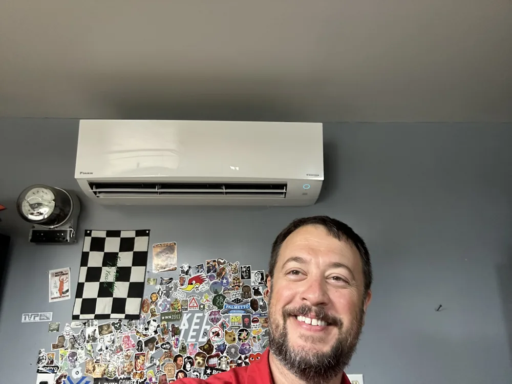 Richard Sitton beside a wall-mounted ductless indoor unit
