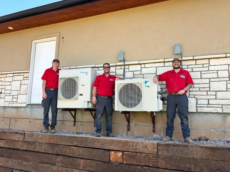 Sitton Mechanical technicians beside installed outdoor HVAC equipment